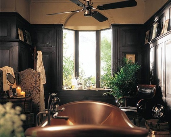 a dark art deco bathroom with black walls, a copper tub and a potted palm tree for a chic and bold look