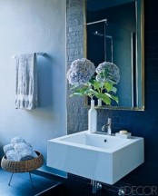 accent your modern bathroom with some blooms in a vase or a bottle to make the space lively and chic