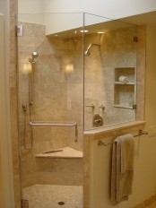 a neutral and warm-colored bathroom with a shower space with a pony wall is a lovely and welcoming space