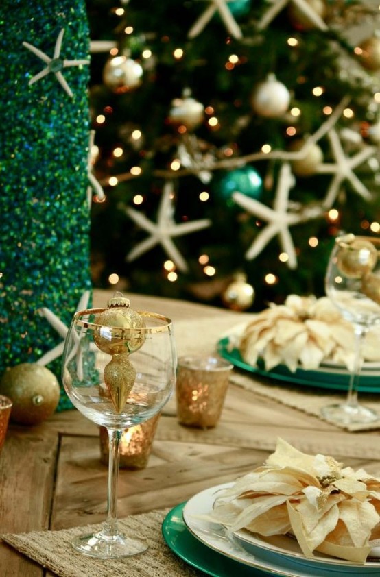 a green faux Christmas tree decorated with star fish, a neutral and green tablescape with metallic ornaments, a Christmas tree with star fish