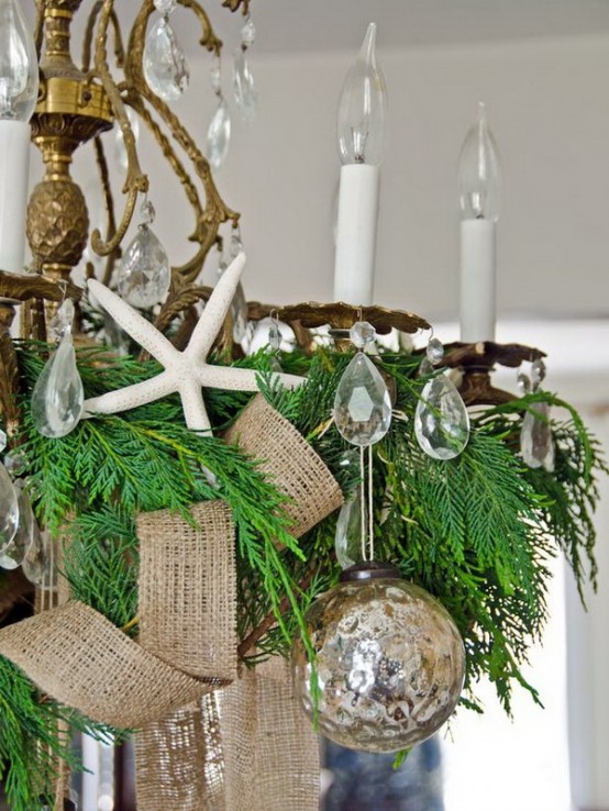 a vintage gilded chandelier with crystals, evergreens, burlap ribbons, mercury glass Christmas ornaments is great for a beach space