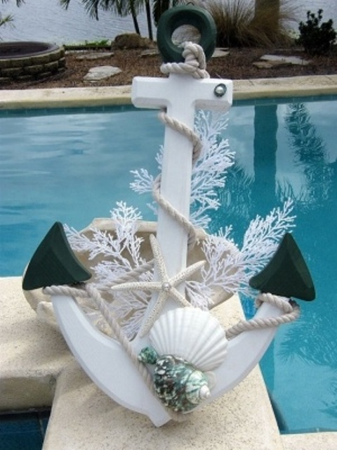 a white anchor with rope, seashells, starfish and corals is a lovely decoration to place outdoors for Christmas