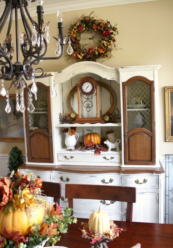 fall arrangements of faux leaves and pumpkins, a dried fall leaf and flower wreath for a fall feel in the dining room