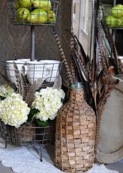 white hydrangeas with feathers, feather arrangements and green pears are great to give a fall feel to the space