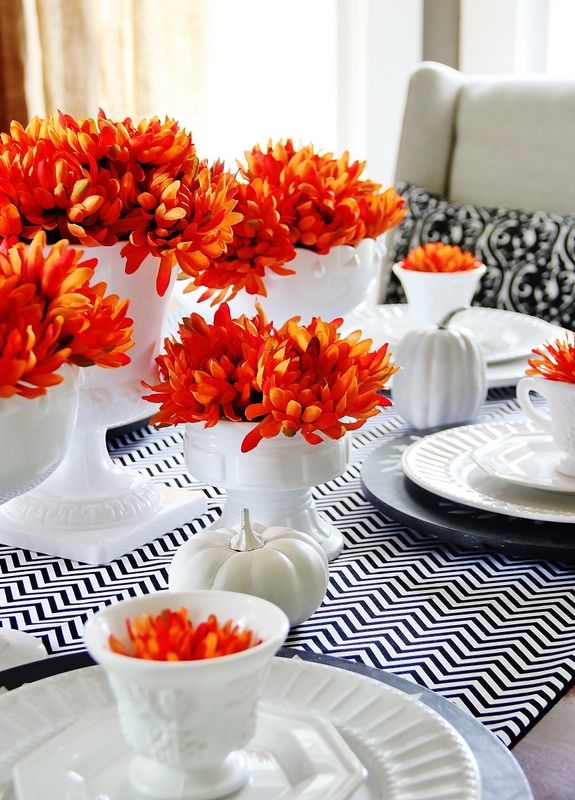 fiery red floral arrangements and neutral pumpkins will be a chic and bright fall centerpiece