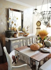 fall leaves on branches, heirloom pumpkins, feathers, a wheat arrangement will make your dining room more fall-like