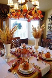 wheat arrangements, faux leaf arrangements and some fake pumpkins will make your dining room feel like fall