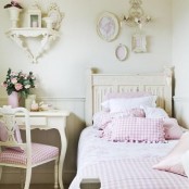 a pretty shabby chic kid’s room with pastel walls and furniture, with pink plaid bedding and upholstery is very girlish and cute