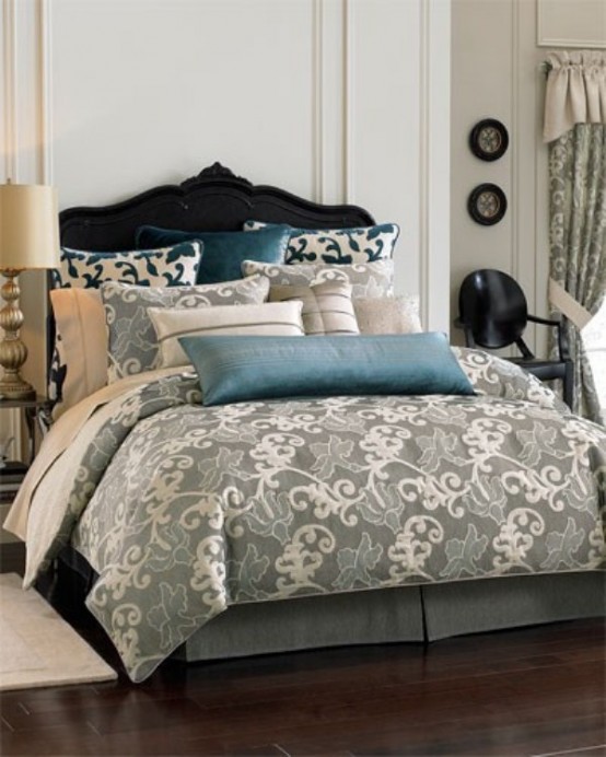 a creamy bedroom with a navy velvet bed, grey and blue bedding with prints