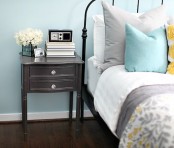 a light blue bedroom and grey, mustard and light blue bedding
