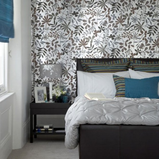a grey and silver bedroom with touches of bold blue is a very refined space