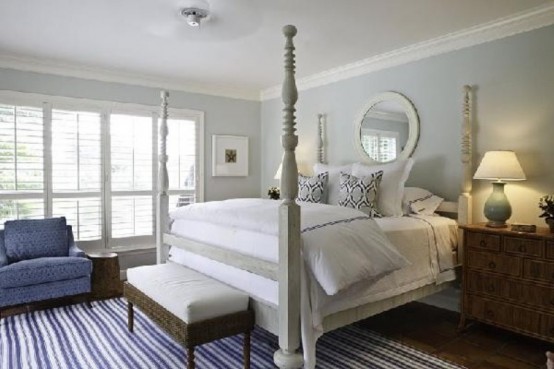 a dove grey vintage-inspried bedroom with touches of bold blue
