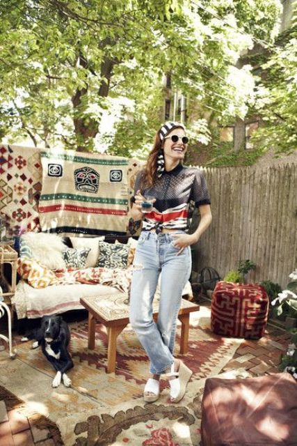 a relaxed boho patio with folksy and boho textiles, pillows, ottomans, rattan and wooden furniture