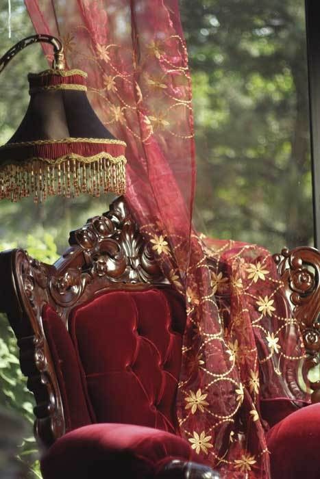 a refined burgundy chair with tufted upholstery and a matching curtain will make your space more fall-like at once