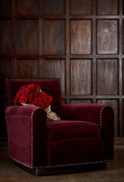 a burgundy velvet chair with decorative nails trim is a statement for a fall space