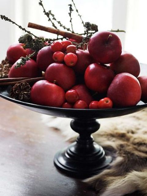 a natural fall centerpiece of a vintage bowl and red fruits and berries of all kinds