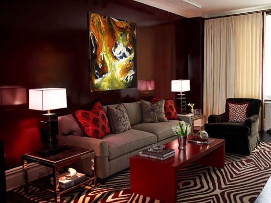 a statement burgundy wall and matching pillows and a coffee table for a bright living room look