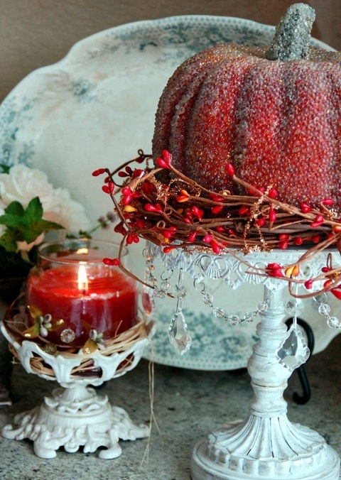 a burgundy candle and a pumpkin on a stand are simple and inexpensive touches to your interior