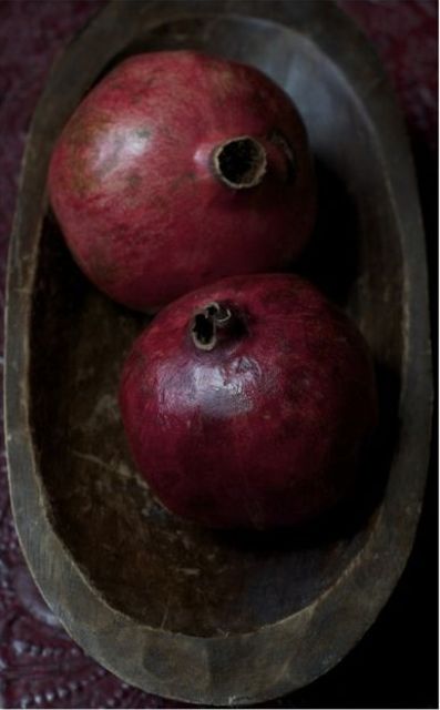 a centerpiece of a metal bowl and a couple of pomegranates for a slight fall feel