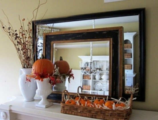 a faux pumpkin arrangement in a basket, a faux pumpkin with leaves in a tall vase and branches in a vase