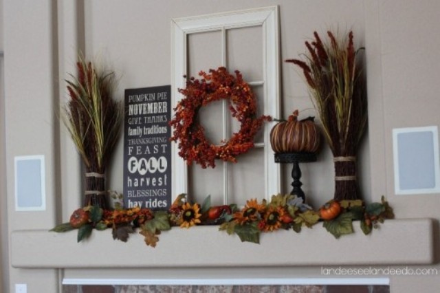 a rustic fall mantel with wheat, fall leaves, faux blooms and pumpkins is all you need to brign a fall feel in