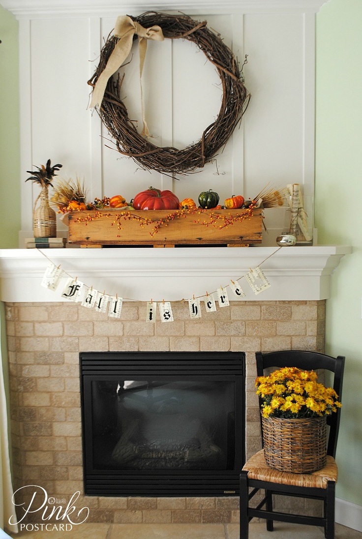 a fall mantel with a large vine wreath, a box with faux pumpkins, leaves, wheat and berries