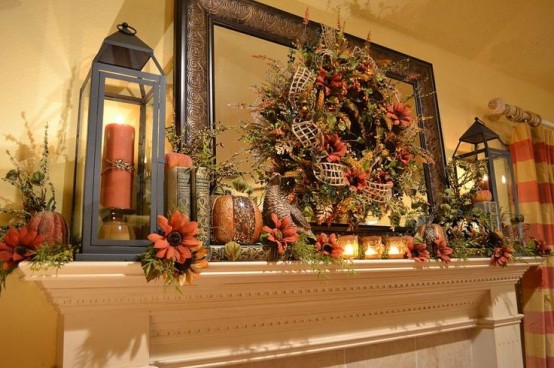 a lush rustic mantel in brown and rust, with faux blooms, leaves, books, candle lanterns and mesh