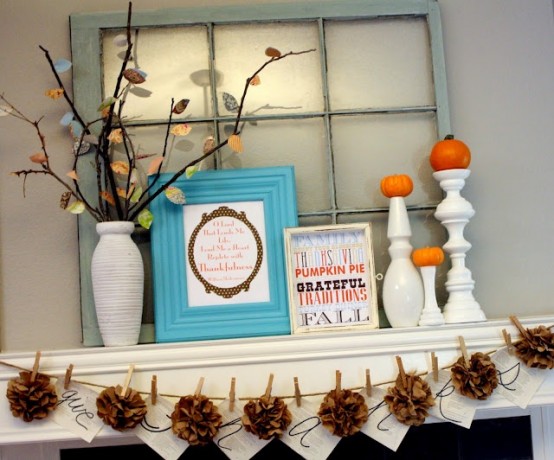 a shabby chic flal mantel with burlap pompoms, branches with bright fall leaves, signs and tiny pumpkins on stands