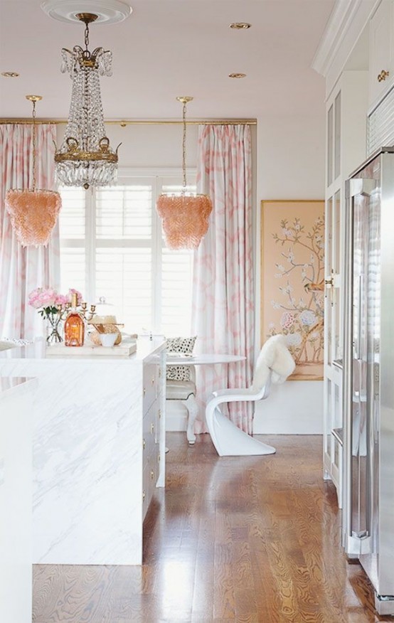 a glam girlish kitchen with white cabinetry, marble and stone countertops, a crystal and pink feather chandeliers and shiny metal touches