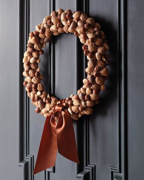 a chic and elegant nut wreath accented with an amber ribbon bow is a lovely idea for stylish fall decor