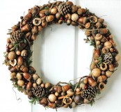 a woodland outdoor decoration with pinecones, nuts, acorns, berries, greenery, twigs, cinnamon sticks and leaves looks beautiful and cool