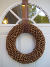 an acorn fall wreath with a brown ribbon is a stylish idea to rock, it will add a natural touch to the space