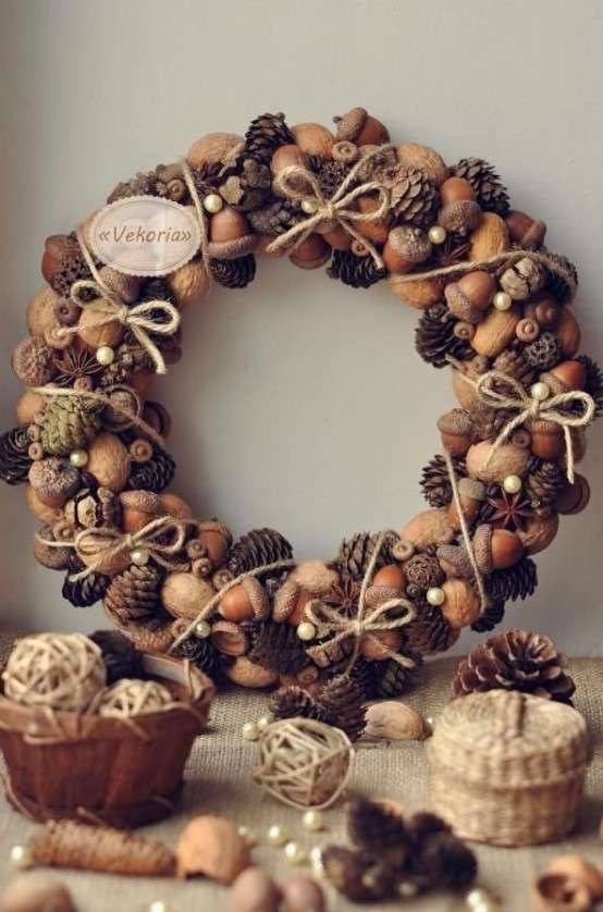 a dreamy fall to winter wreath with nuts, acorns, pinecones, twine bows and beads and pearls is a lovely decoration with a slight touch of glam