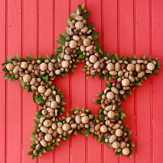 a star shaped wreath made of nuts and acorns, with some greenery is a lovely decor idea with a catchy shape and a lovely look