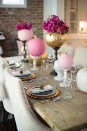 bright pink and gold pumpkins with bold blooms on stands will spruce up your Thanksgiving tablescape