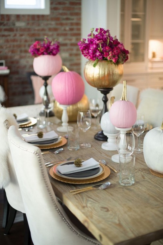 bright pink and gold pumpkins with bold blooms on stands will spruce up your Thanksgiving tablescape