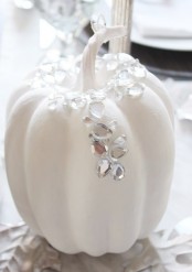 an elegant and glam white pumpkin with rhinestones is a chic and glam Thanksgiving decoration