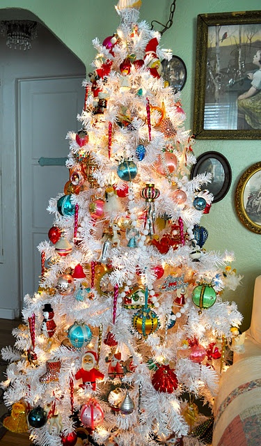 a white Christmas tree done with lights and bright vintage Christmas ornaments looks bold and very enchanting