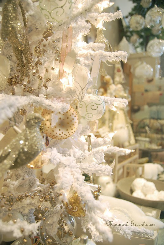 a neutral vintage Christmas tree with ornaments, metallic touches to shine and fabric blooms
