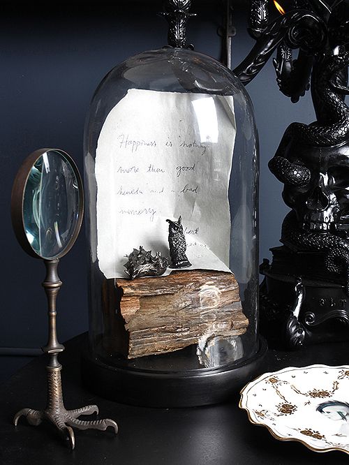a vintage cloche with wood, a note and some black figurines is always an elegant and cool idea for a vintage Halloween space