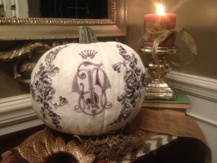 a white pumpkin with black patterns on it is a very chic and refined Halloween decoration for a chic and cool party