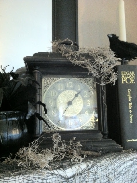 a black vintage clock with moss and a blackbird is a lovely decor idea for a vintage Halloween party