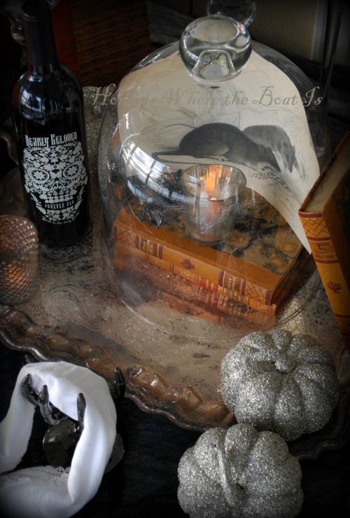 vintage books, a cloche with a candleholder, some ravens and silver pumpkins for lovely vintage Halloween decor