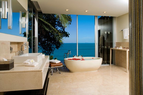 a contemporary luxurious bathroom in beige, brown and stainless steel and a glass window with the views