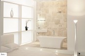 a beige and white bathroom with a catchy tub and frosted glass