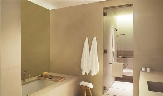 a taupe and white bathroom with touches of dark shades looks very elegant and contemporary