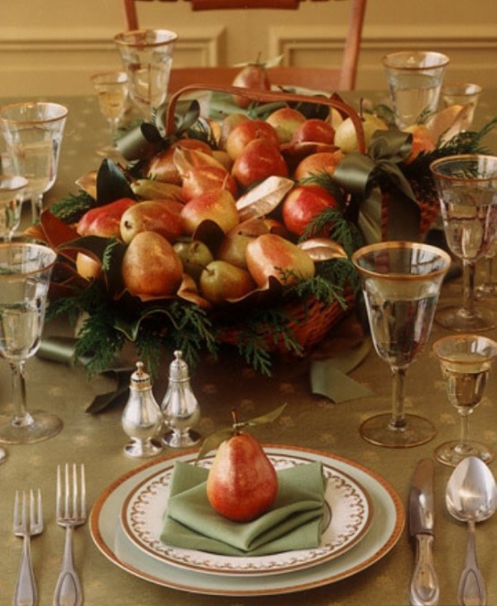an elegant yet rustic Thanksgiving centerpiece of a woven tray, pears, greenery and ribbon bows is a beautifil and cool idea
