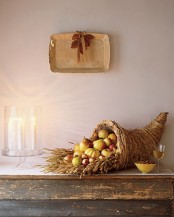 a large cornucopia filled with pears, apples, gourds and wheat is a lovely idea that feels like Thanksgiving for real