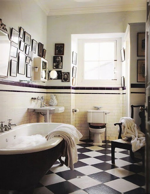 Creating an art gallery wall in a bathroom isn't an obvious decorating decision but it looks like it pull it off!