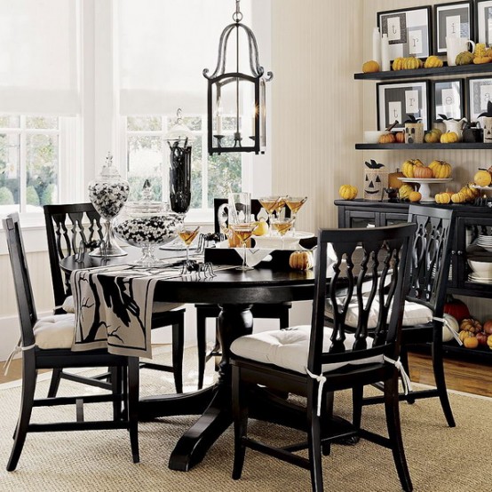 a rustic black and white dining room with open shelves and a buffet, a vintage black and white dining set and a pendant lantern